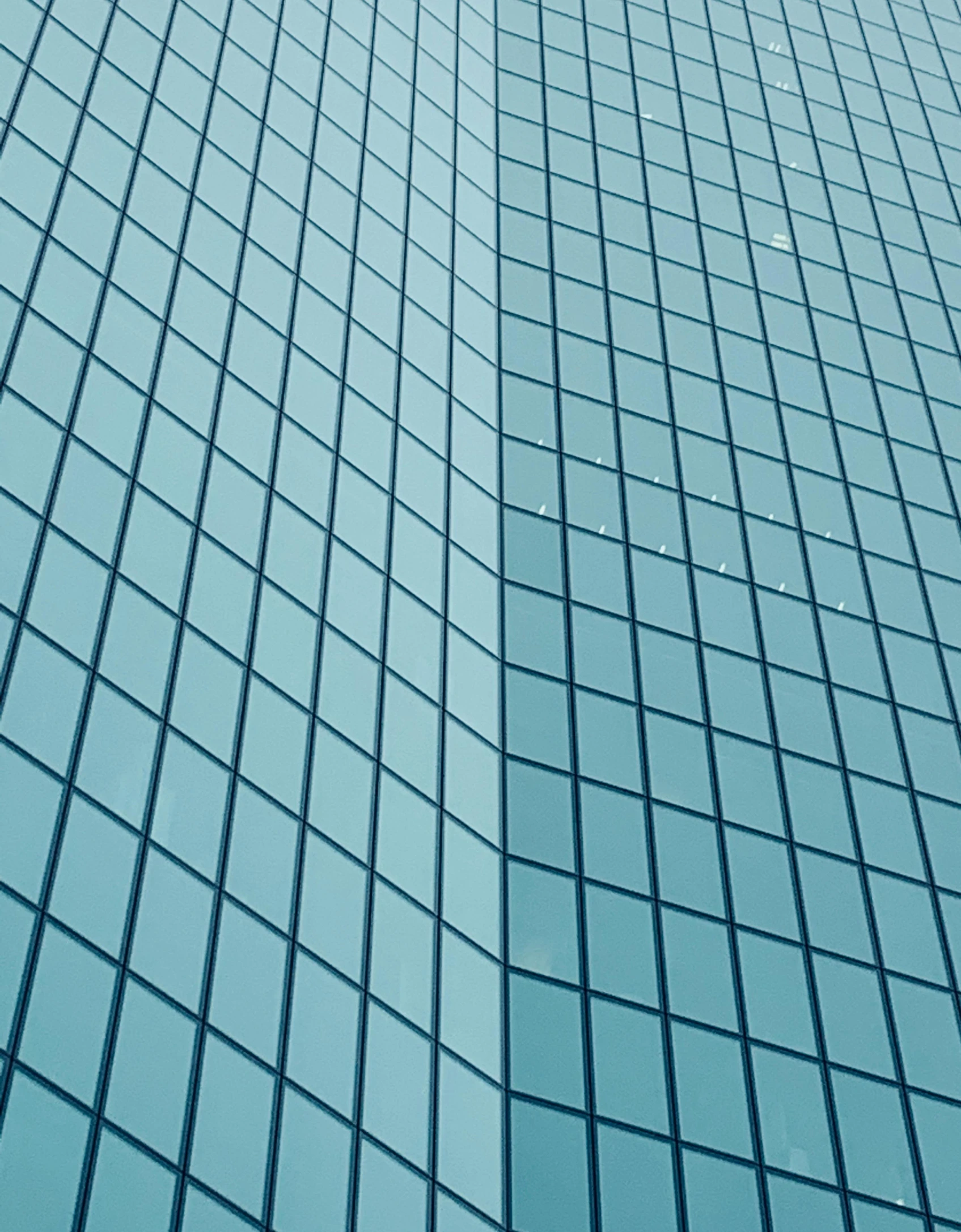 a tall building with a blue sky in the background, teal paper, square lines, glass texture, megabuildings