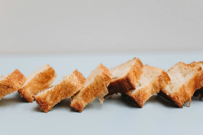 a close up of slices of bread on a table, by Carey Morris, unsplash, minimalism, close up of single sugar crystal, square lines, ignant, cereal