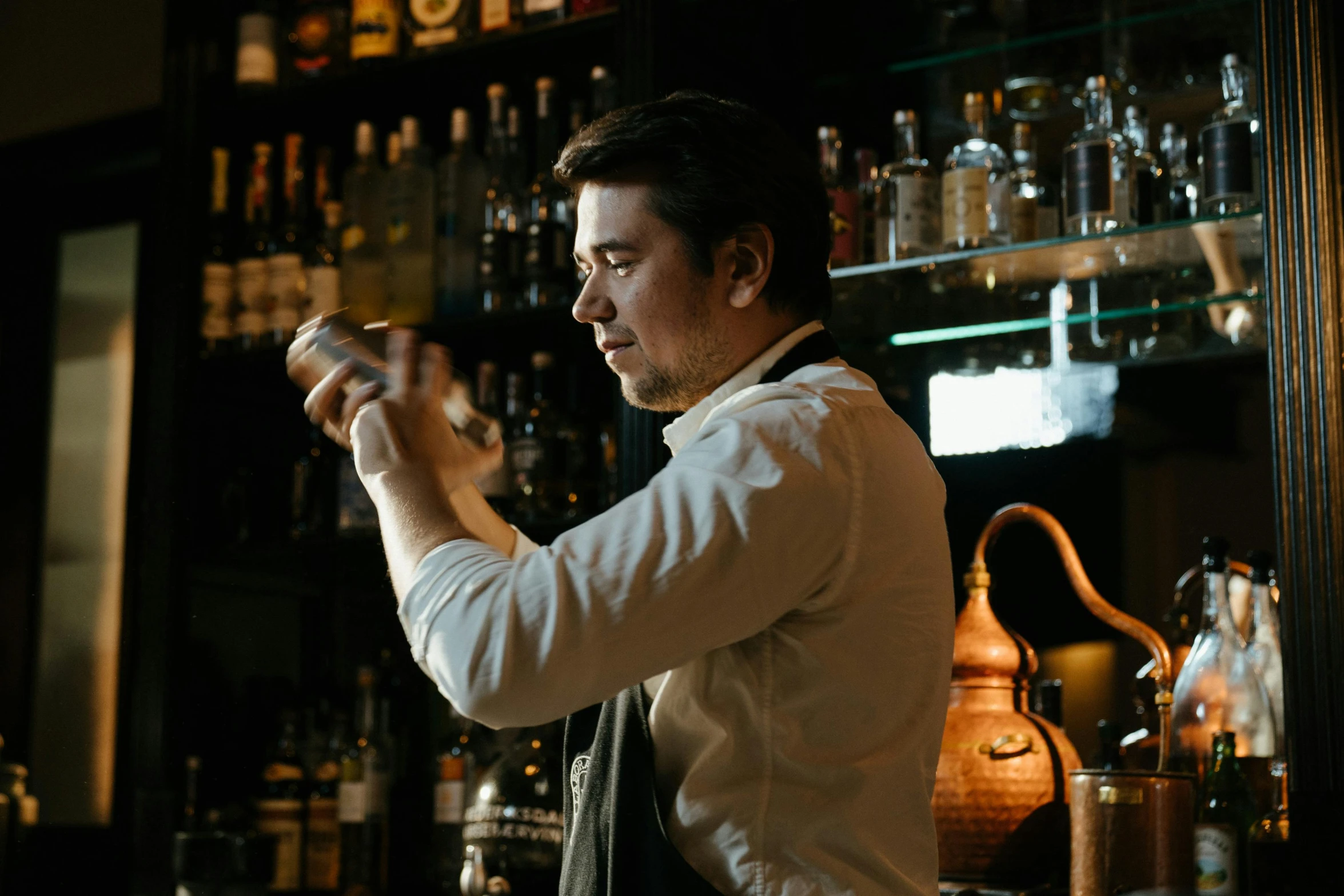 a man that is standing in front of a bar, pouring techniques, profile image, lachlan bailey, tom burke