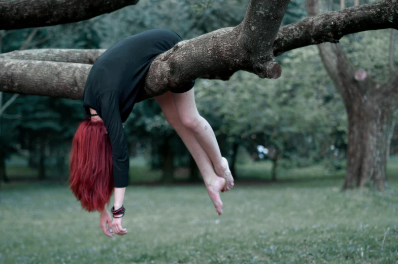 a woman hanging upside down from a tree branch, pexels contest winner, magic realism, ( redhead, 15081959 21121991 01012000 4k, levitating above the ground, very sad