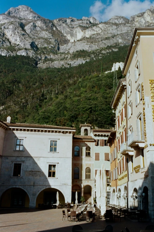 a clock that is on the side of a building, an album cover, inspired by Bernardo Bellotto, renaissance, dolomites, 1987 photograph, panoramic, 1999 photograph