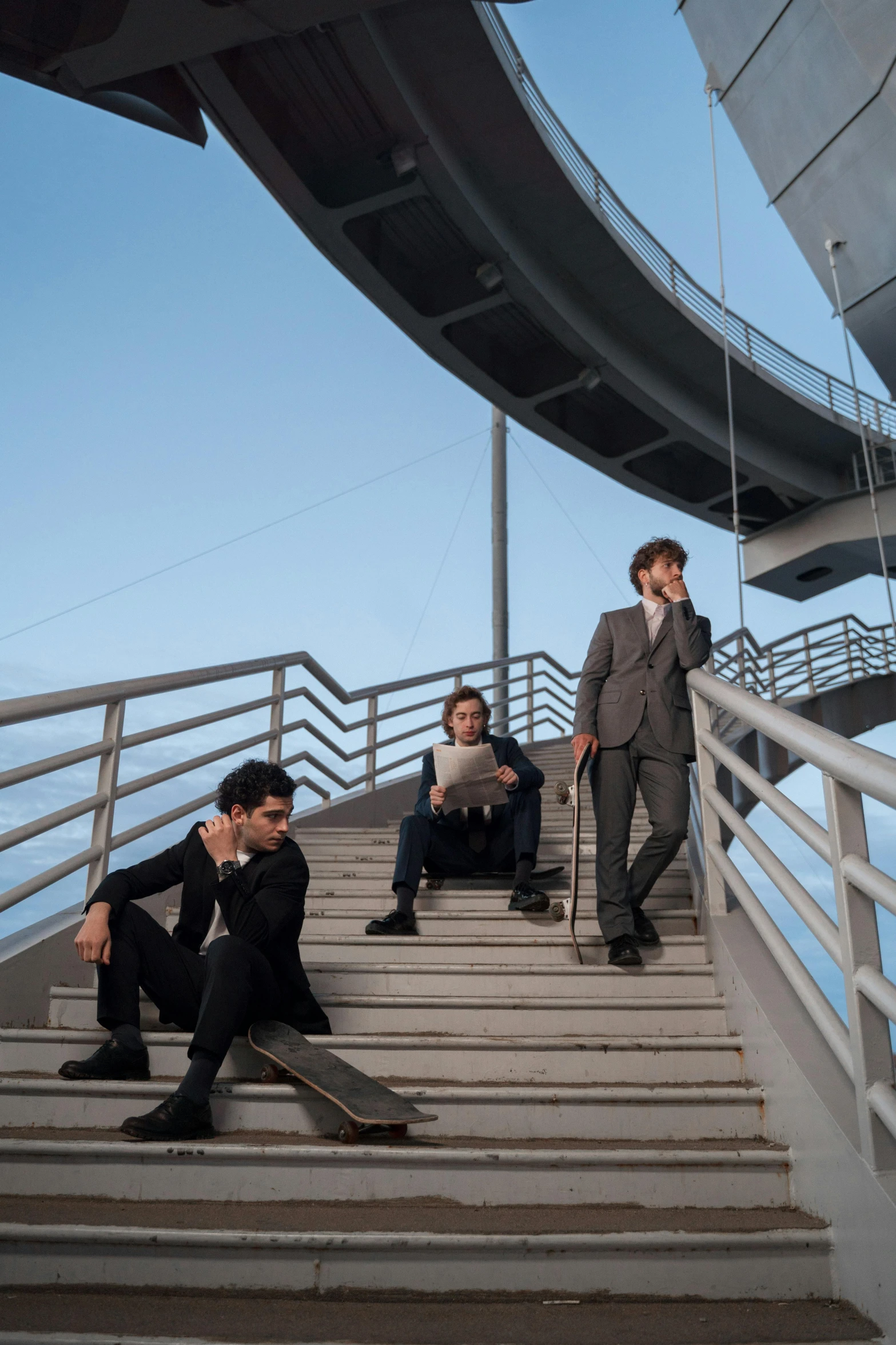 a group of men sitting on top of a set of stairs, an album cover, by Alejandro Obregón, pexels contest winner, bauhaus, sky bridge, three - quarter view, serious business, on ship