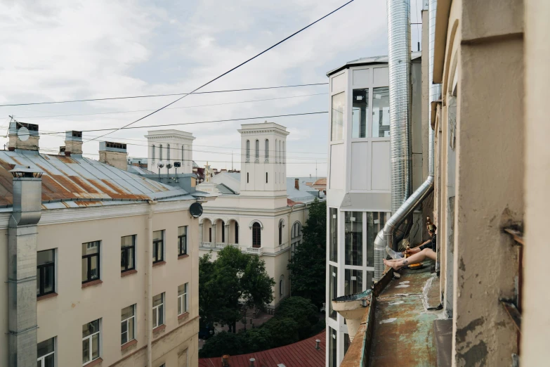 a couple of buildings that are next to each other, a photo, unsplash contest winner, socialist realism, balcony, 000 — википедия, khreschatyk, slightly tanned