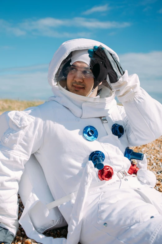 a man in an astronaut suit sitting on a beach, inspired by Jan de Baen, unsplash, renaissance, cai xukun, charli xcx, full costume, tardigrade in space