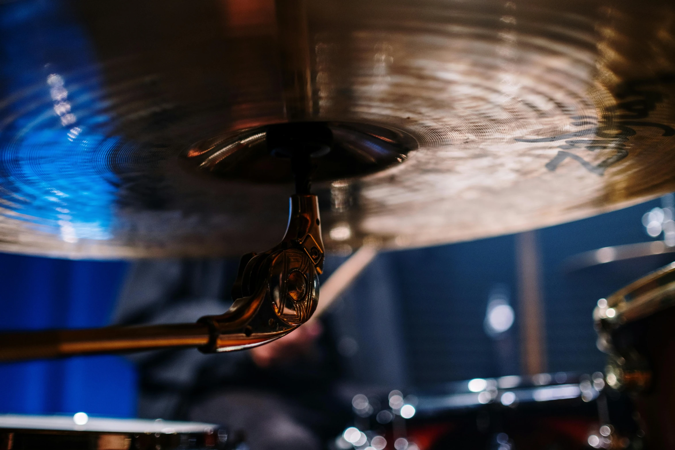 a close up of a drum on a stage, by Jay Hambidge, pexels contest winner, hurufiyya, cinematic view from lower angle, solid background, smooth metal, lachlan bailey