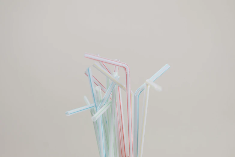 a glass filled with different colored drinking straws, an album cover, unsplash, plasticien, pale sober colors 9 0 %, detailed product shot, striped, 1 9 5 0 s