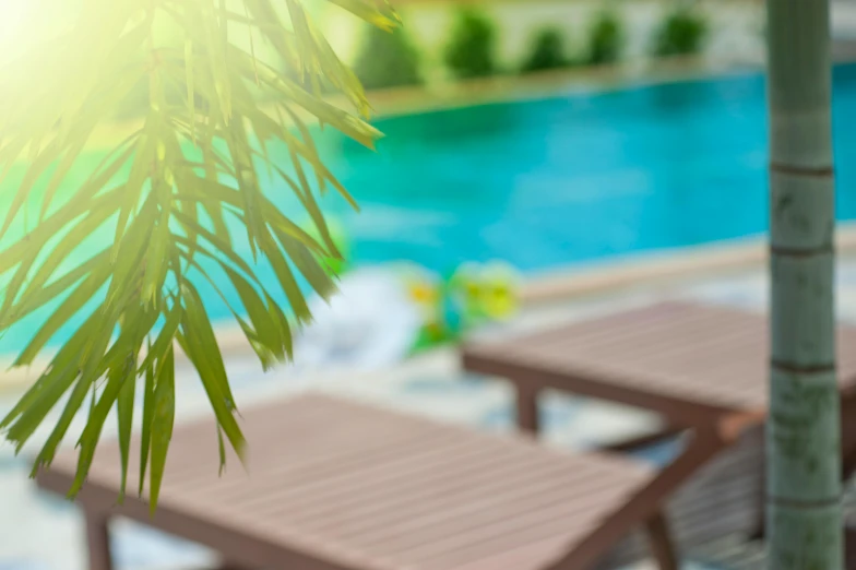 a couple of lounge chairs sitting next to a swimming pool, pexels contest winner, square, fan favorite, commercial banner, summer sunlight