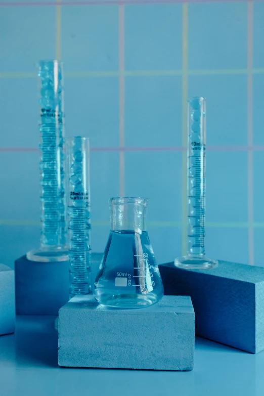 a couple of vases sitting on top of a table, futuristic chemistry lab, blue archive, clear liquid, mit technology review