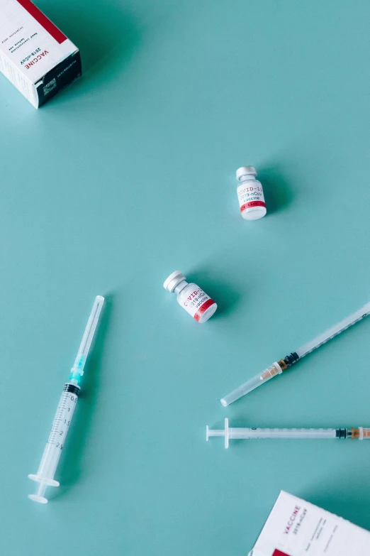 a variety of medical supplies laid out on a blue surface, by Sebastian Vrancx, trending on pexels, visual art, syringe, red and cyan, 15081959 21121991 01012000 4k, ilustration