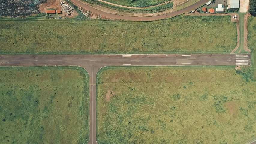 an aerial view of a small airport, an album cover, by Attila Meszlenyi, unsplash, conceptual art, road, grass field surrounding the city, maintenance photo, gemmy woud - binendijk