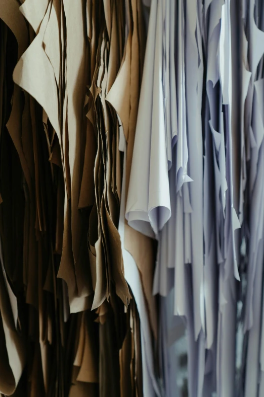 a bunch of shirts hanging on a rack, unsplash, renaissance, gradient brown to silver, made of silk paper, wearing leather, messy lines