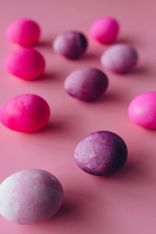 a bunch of different colored balls on a pink surface, pexels contest winner, egg, gradient dark purple, made of candy, (pink colors)