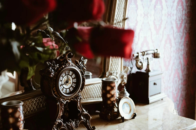 a clock sitting on top of a table next to a vase of flowers, a still life, unsplash, rococo, red roses, steampunk trim, an interior of room, thumbnail