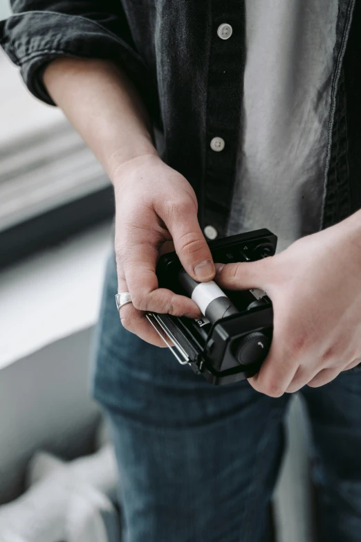 a close up of a person holding a camera, quick assembly, holding a small vape, detailed product image, medium height