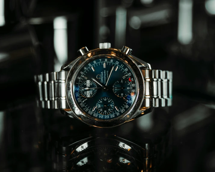 a close up of a watch on a table, pexels contest winner, photorealism, blue silver and black, thumbnail, breitling, cinematic outfit photo