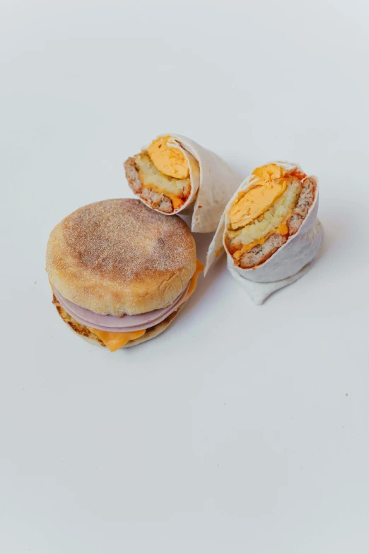 two sandwiches sitting next to each other on a white surface, a picture, unsplash, crispy buns, melted cheddar, mr sandman, full product shot