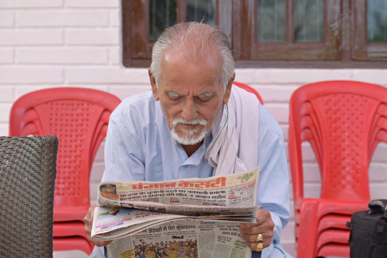 a man sitting on a chair reading a newspaper, by Bapu, pexels contest winner, private press, oldman with mustach, avatar image, 15081959 21121991 01012000 4k, uttarakhand