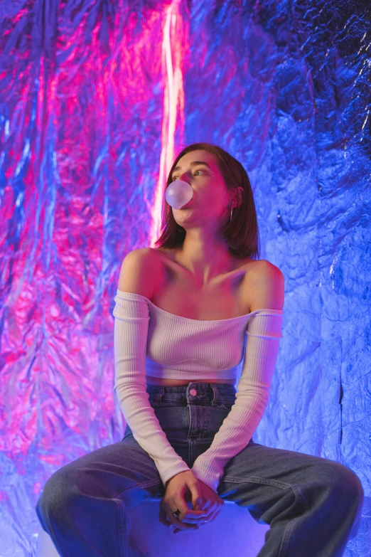 a woman sitting on a stool with a bubble in her mouth, inspired by Elsa Bleda, pexels contest winner, holography, crop top, cotton candy, neon accent lights, dilraba dilmurat