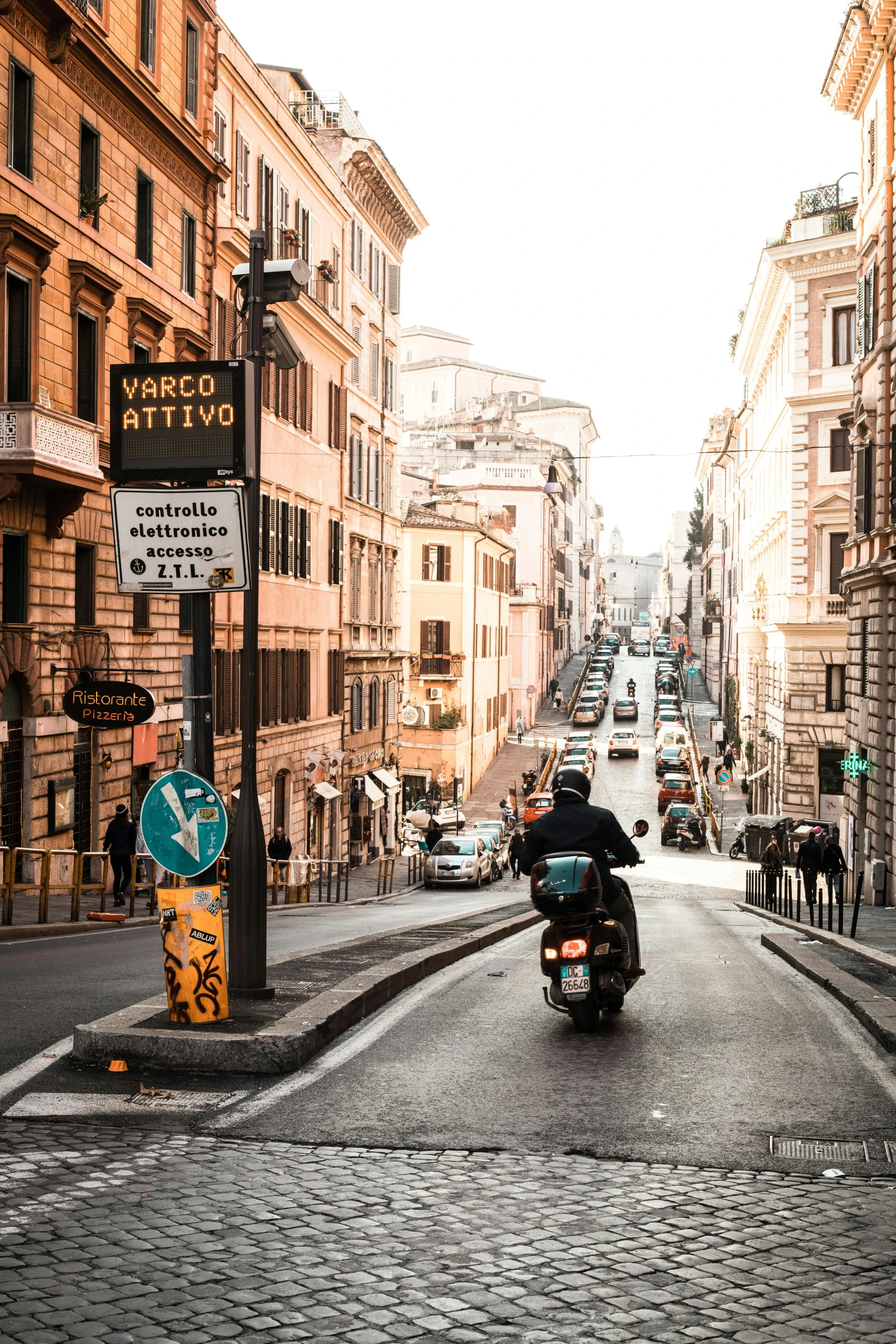 a man riding a motorcycle down a street next to tall buildings, pexels contest winner, renaissance, eternal city, street signs, van, a quaint