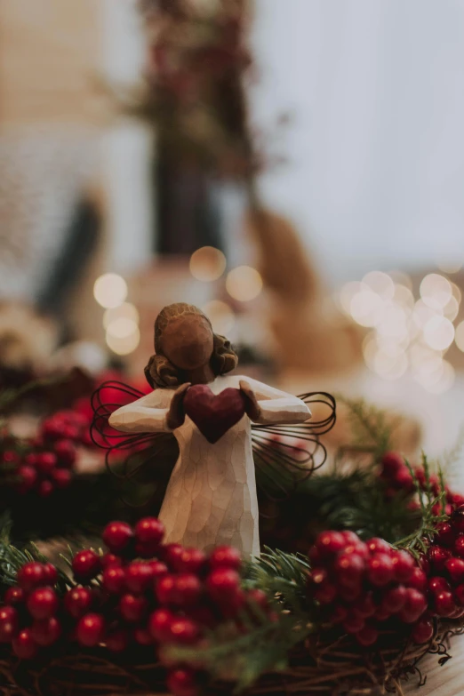 a couple of figurines sitting on top of a table, holiday vibe, spreading her wings, small heart - shaped face, bokeh details