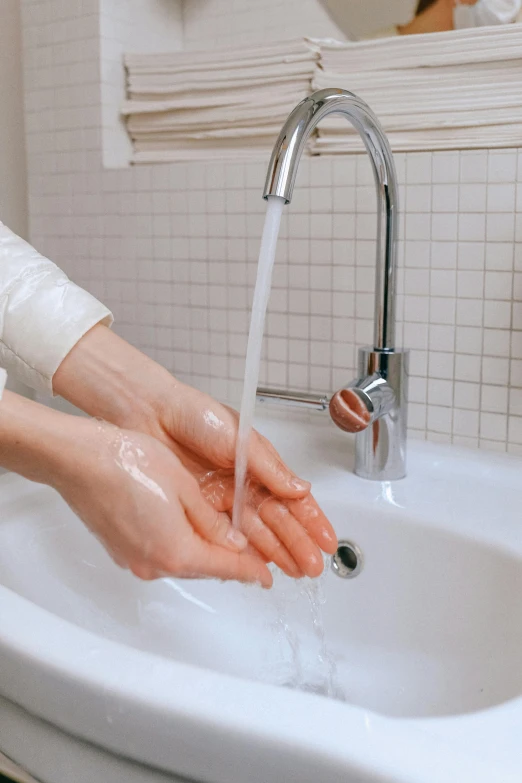 a woman washing her hands under a faucet, pexels contest winner, renaissance, synthetic bio skin, piping, thumbnail, japanese