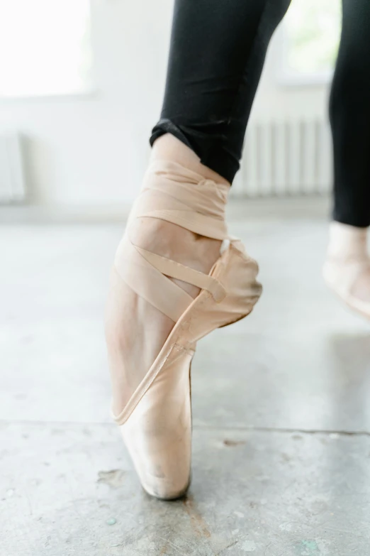 a close up of a person's feet in ballet shoes, inspired by Elizabeth Polunin, arabesque, bandages, standing on a desk, caparisons, innovation