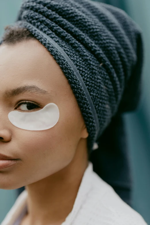 a woman with eye patches on her face, trending on pexels, square, photoshoot for skincare brand, eyes rolled back, manuka