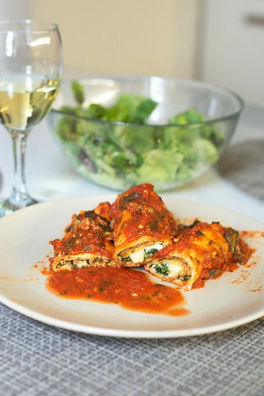 a white plate topped with lasagna next to a glass of wine, inspired by Antonio Rotta, unsplash, greens), square, 6 pack, stuffed