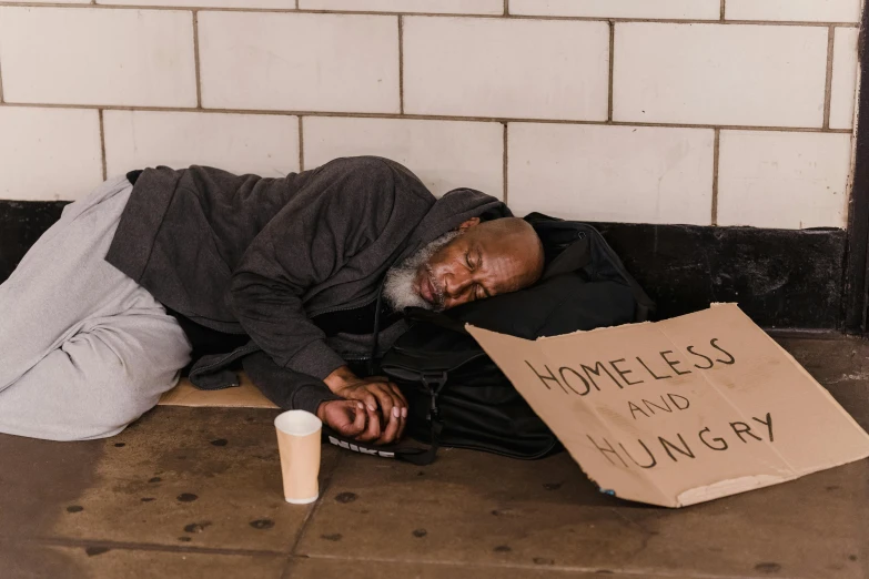 a homeless man is sleeping on the sidewalk, by Matija Jama, pexels contest winner, renaissance, dave chappelle, morgan freeman, profile image, youtube thumbnail