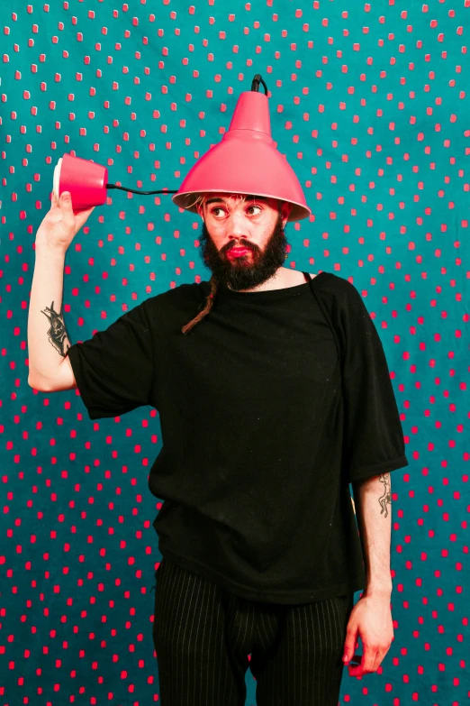a man with a beard wearing a pink hat, an album cover, by Ludovit Fulla, awkwardly holding red solo cup, cone heads, press photo, backdrop