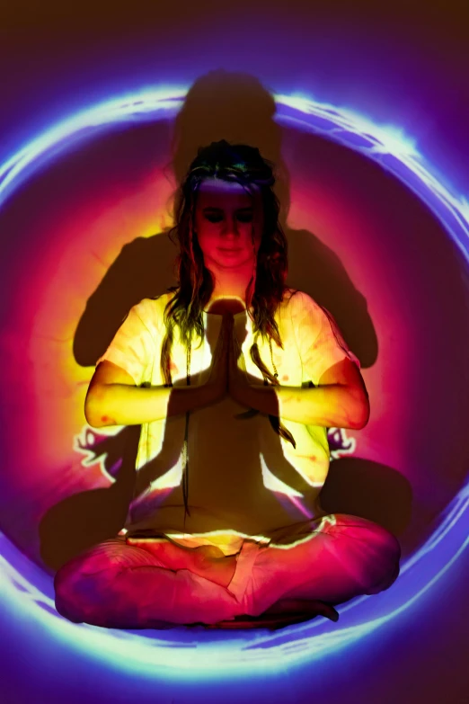 a woman sitting in the middle of a circle of lights, a hologram, inspired by David LaChapelle, psychedelic art, kundalini energy, press shot, add a glow around subj. edge, glow around helmet