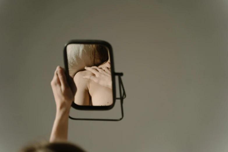 a woman taking a picture of herself in a mirror, inspired by Anna Füssli, trending on pexels, conceptual art, paul barson, back of head, ignant, julia hetta