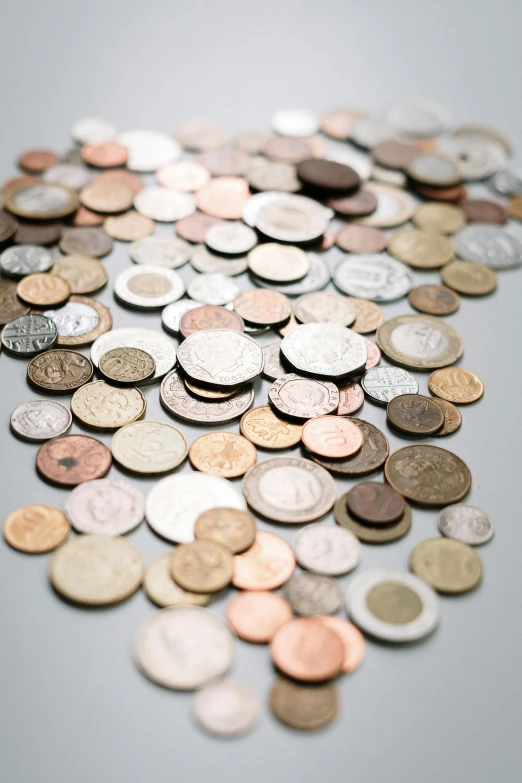 a pile of coins sitting on top of a table, thumbnail, shot on sony a 7, detailed product image, multicoloured