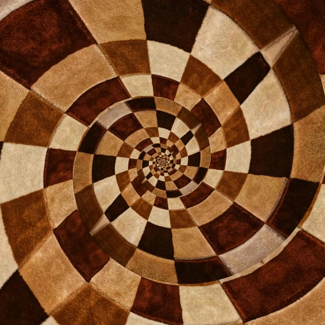 a brown and white rug with a circular design, pexels contest winner, abstract illusionism, spiral horns!, escher, quilt, chocolate art