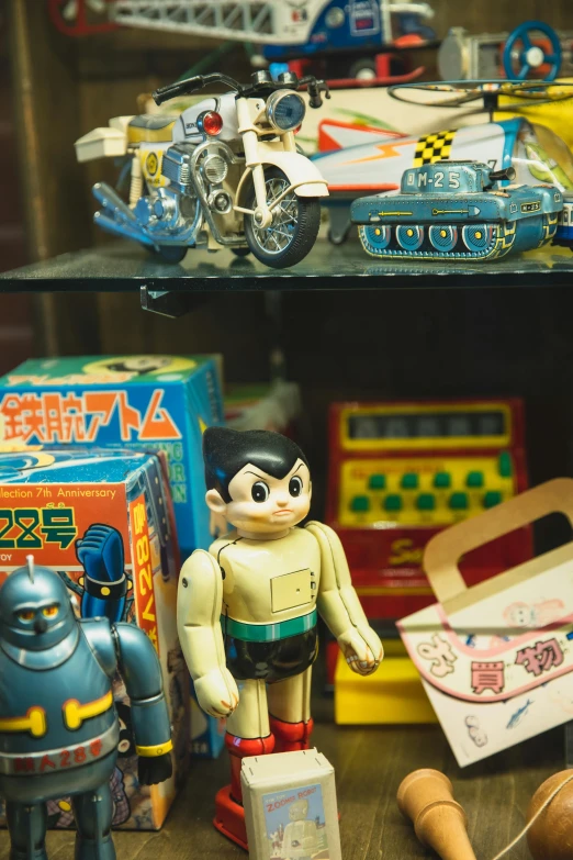 a collection of toys sitting on top of a wooden table, mingei, vintage showcase of the 60s, robot, doraemon, contain