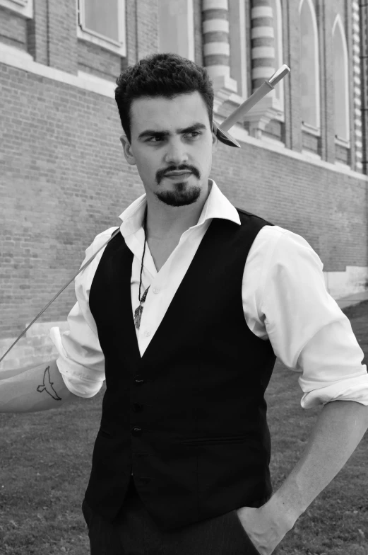 a black and white photo of a man standing in front of a building, inspired by Ramon Pichot, reddit, renaissance, white waistcoat, actor, drew hill, attractive man
