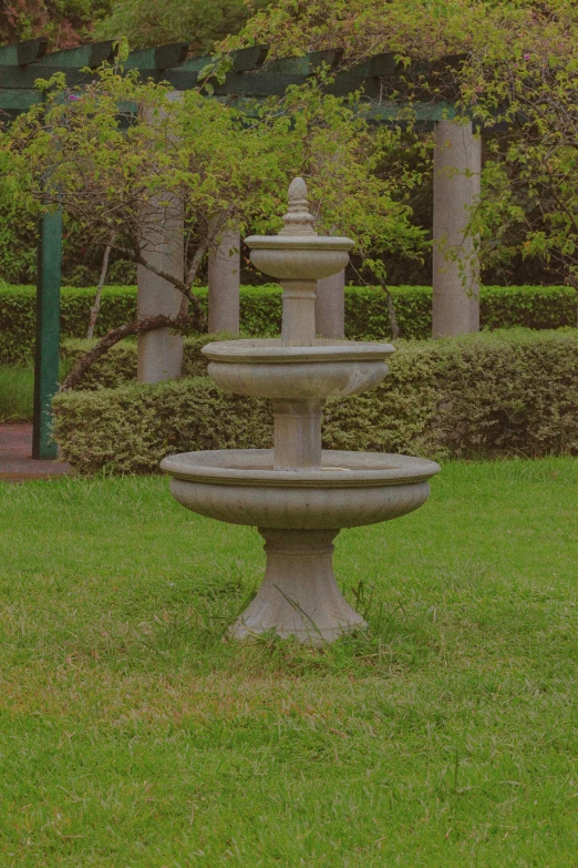 a fountain sitting in the middle of a lush green park, 165 cm tall, listing image, against dark background, limestone