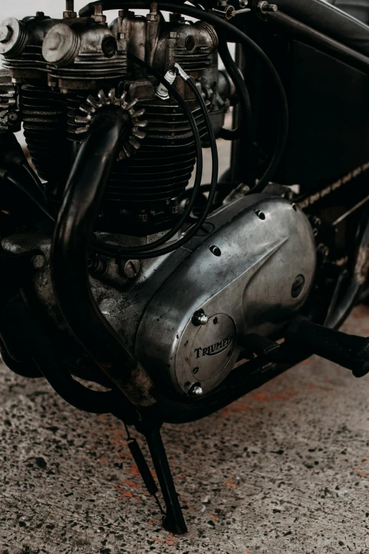 a motorcycle parked on the side of the road, pexels contest winner, photorealism, closeup of car engine, 1954, metal plate photograph, triumph