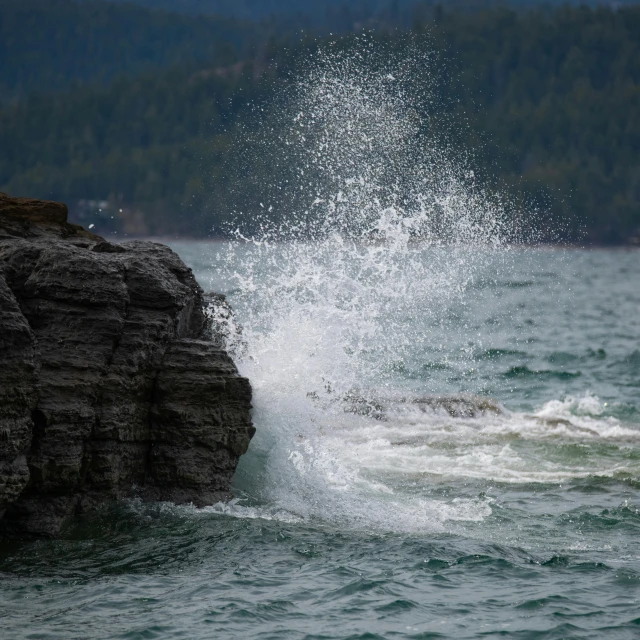 a man riding a surfboard on top of a wave, by Jim Nelson, pexels contest winner, organic swirling igneous rock, glacier national park, ocean sprites, hunting