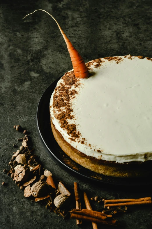 a carrot cake sitting on top of a black plate, by Jan Tengnagel, dribble, tulip, white with chocolate brown spots, official product image, chiffon