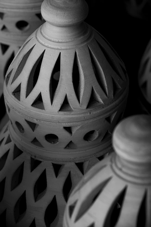 a group of white lanterns sitting on top of a table, an ambient occlusion render, inspired by Alberto Morrocco, baroque, made out of clay, close-up photograph, made of cement, dark intricate