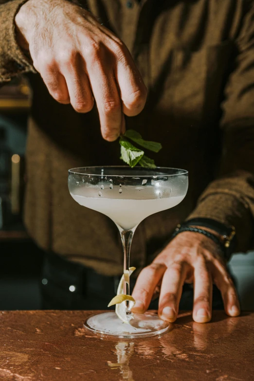 a man preparing a cocktail at a bar, by Ndoc Martini, unsplash, renaissance, detailed white, basil gogos, thumbnail, hands