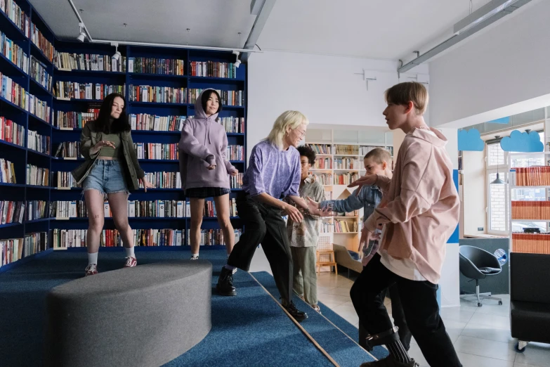 a group of people playing a video game in a library, by Jaakko Mattila, danube school, people dancing, weta studio and james jean, lachlan bailey, cai xukun