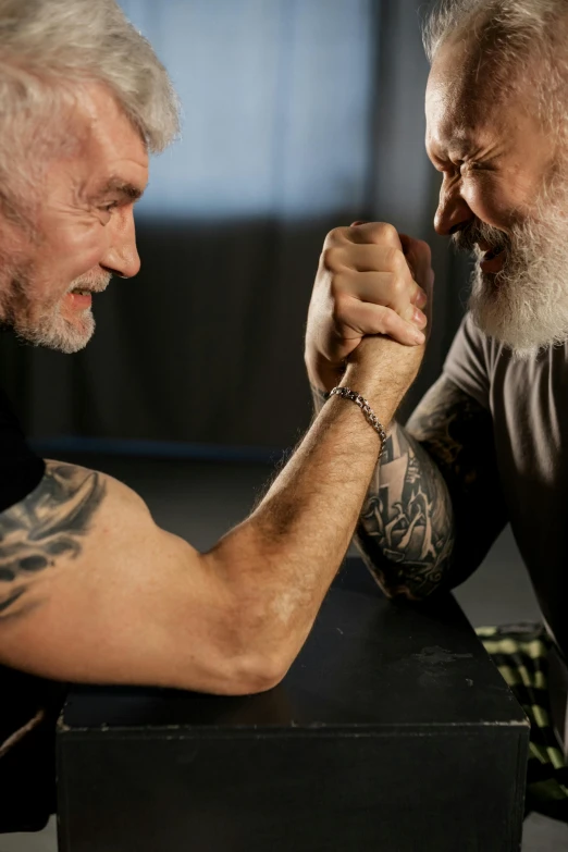 two men arm wrestling each other in a gym, a tattoo, pexels contest winner, old gigachad with grey beard, profile image, brian jacques, square