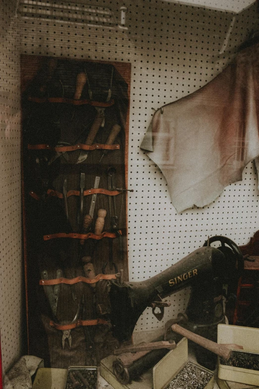 a room filled with lots of clutter and tools, a cross stitch, pexels contest winner, assemblage, inside an old weapon shop, thumbnail, leather, vintage aesthetic