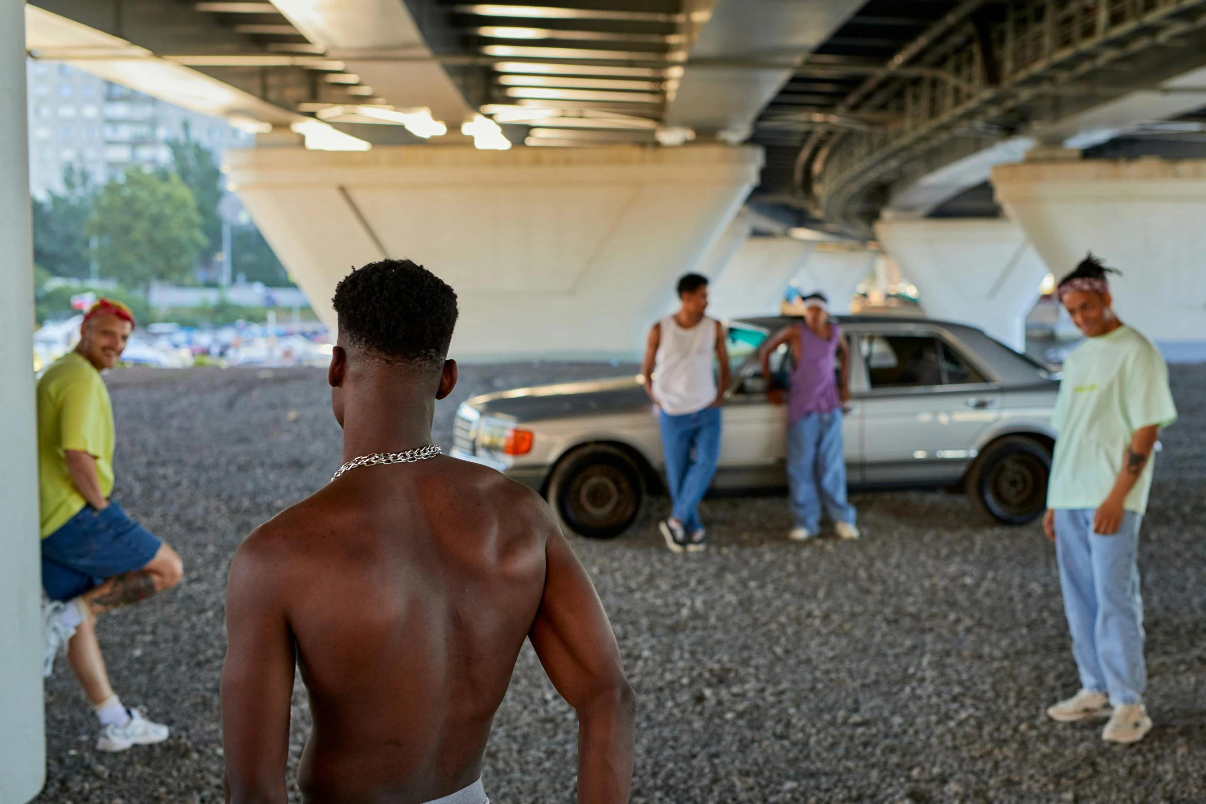 a group of men standing next to each other under a bridge, inspired by Bruce Davidson, visual art, standing in front of lowrider, xxxtentacion, gettyimages, black teenage boy