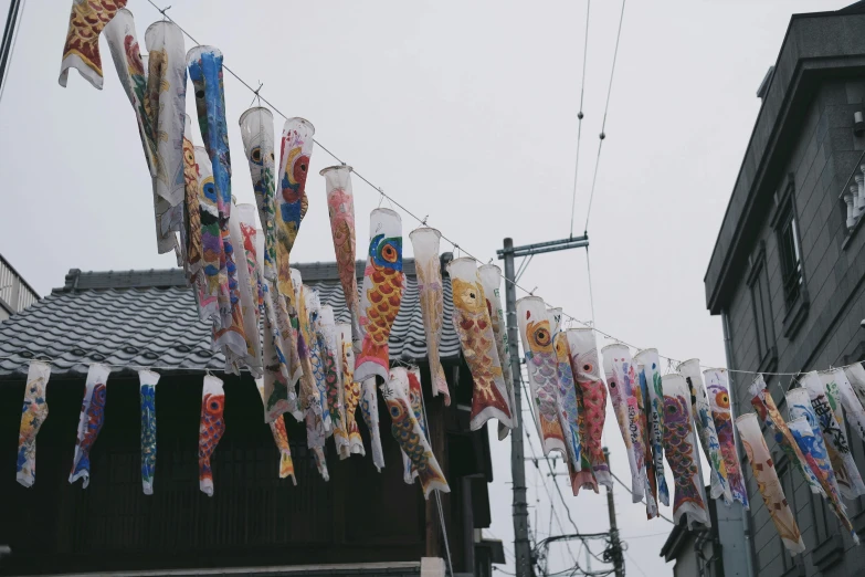 a bunch of kites hanging on a clothes line, unsplash, sōsaku hanga, old shops, jellyfish shrine maiden 8k, 🚿🗝📝