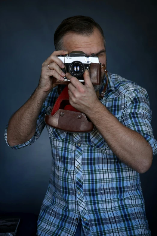 a man taking a picture with a camera, inspired by Camilo Egas, upper body face shot, color, professional photo-n 3, photography]