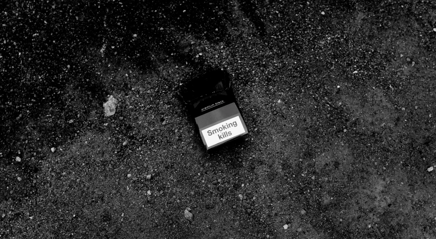 a black and white photo of a cell phone on the ground, by Anato Finnstark, taking tobacco snuff, medium format. soft light, silent hill aesthetic, the black box