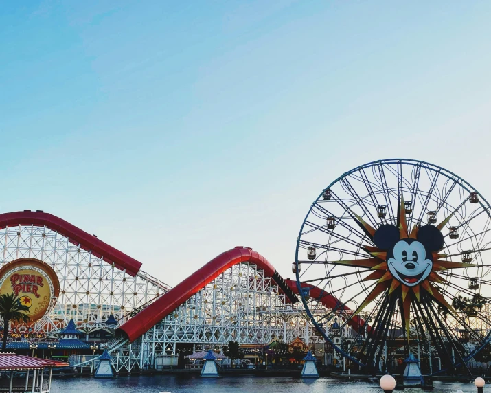 a number of amusement rides near a body of water, inspired by disney, pexels contest winner, california;, profile image, mismatched, mouse photo